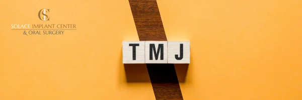 letter tiles spelling out tmj