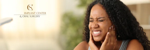 a young woman suffering tmj jaw pain
