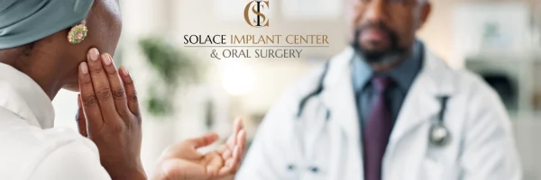 a dental professional consulting a woman about her TMJ jaw pain